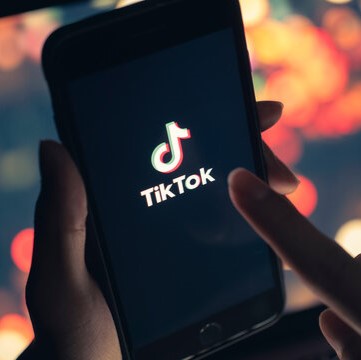 TikTok app on a phone screen, showcasing Moonroute Media's expertise